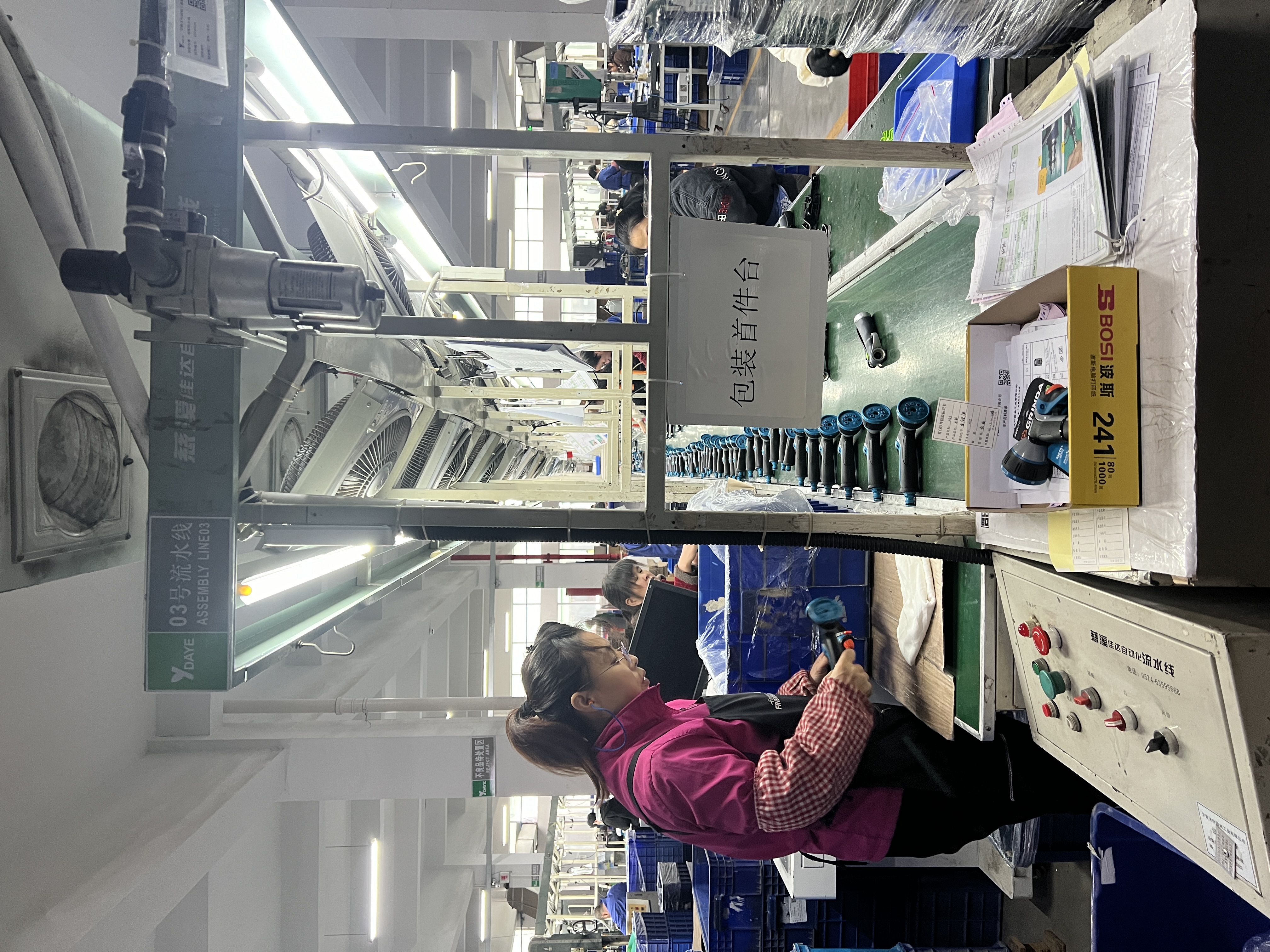Assembly line and packing station in a manufacturing facility